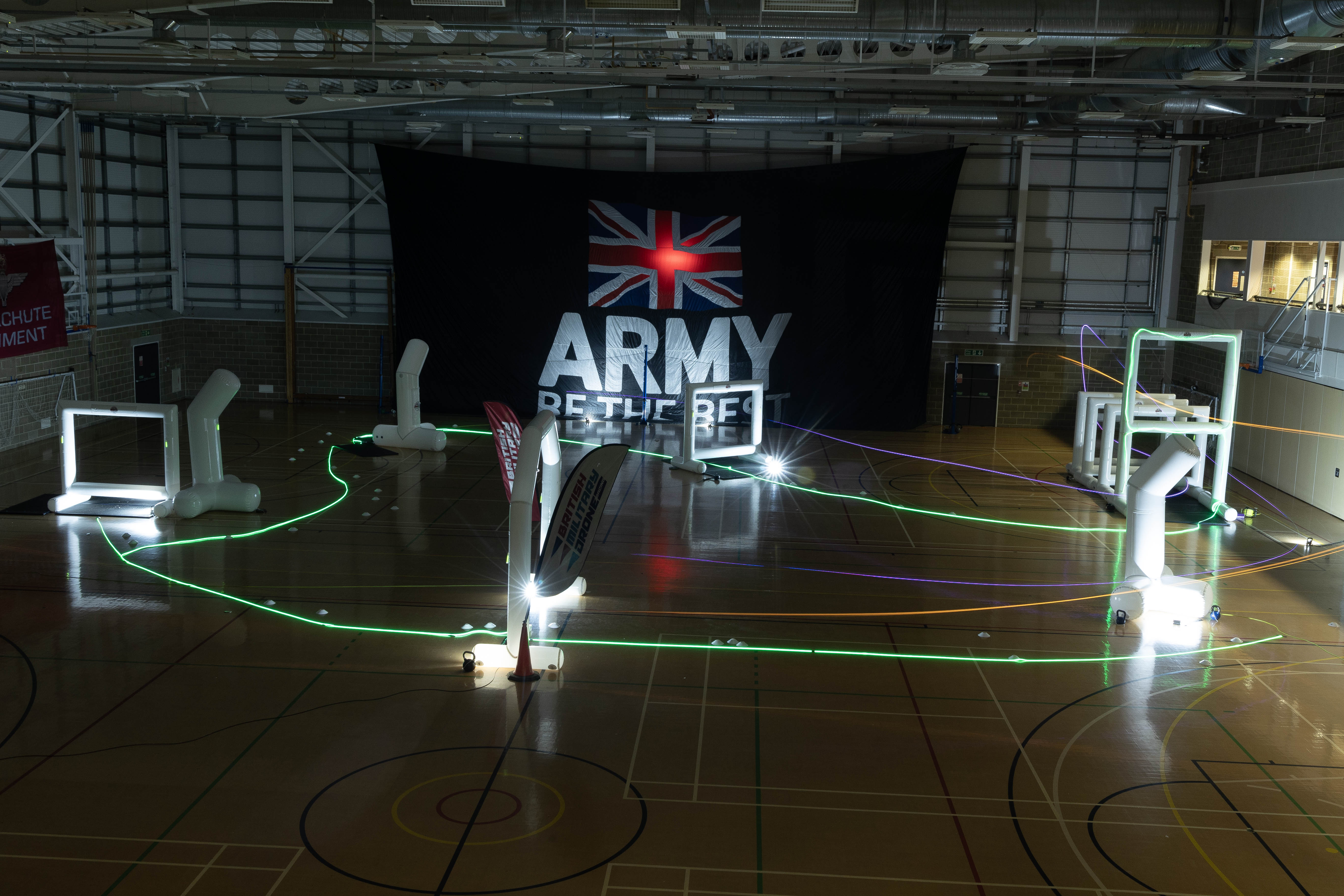 Photo: Drones racing in the dark around a set course.